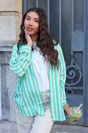 model draagt groen wit gestreepte blouse met witte top en broek