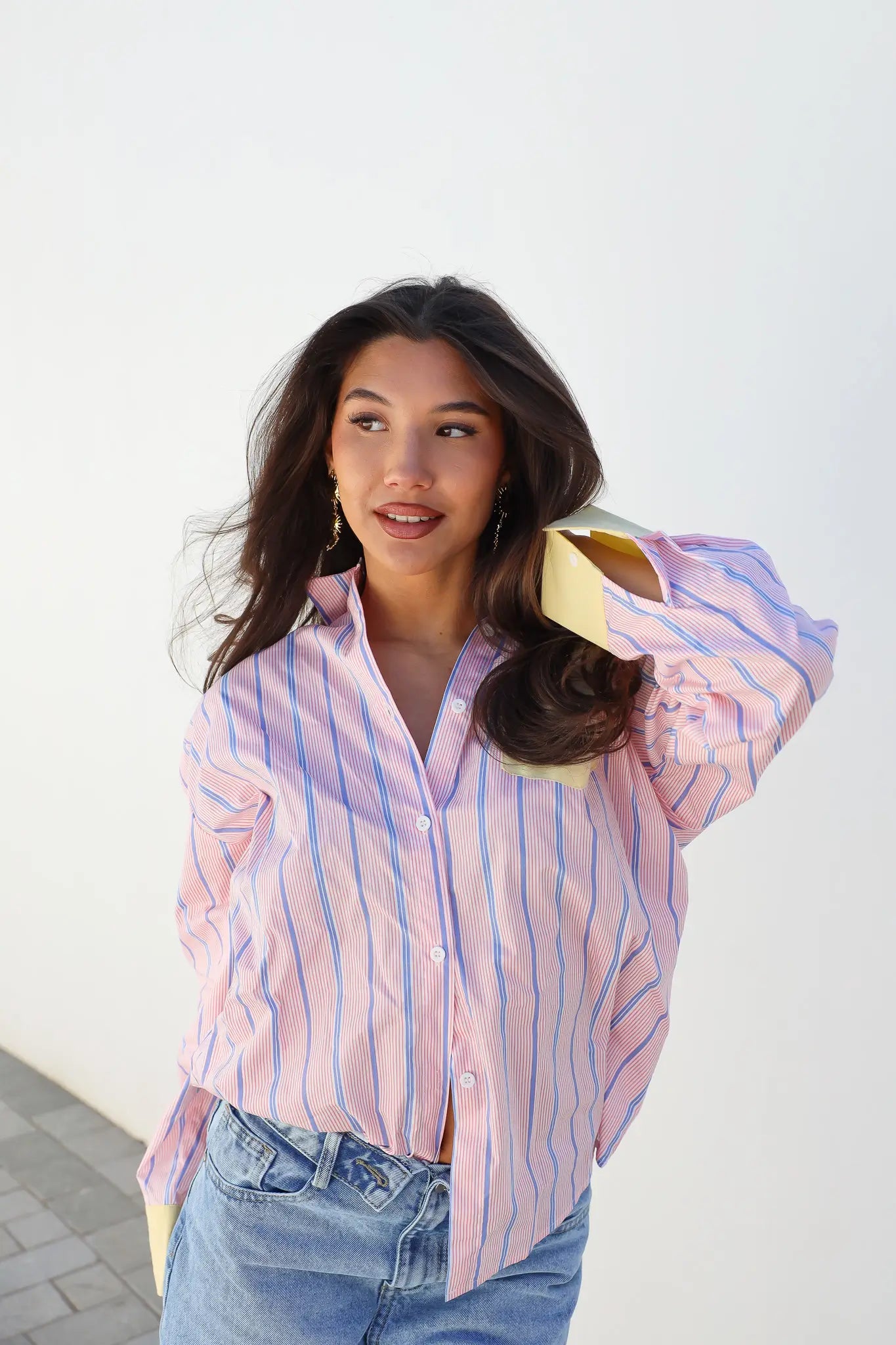 Model draagt blouse strepen roze geel pose