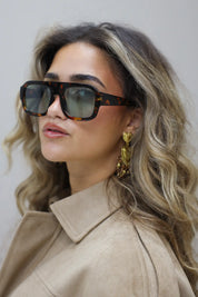 model met los haar en beige blouse kijkt opzij met rustige blik