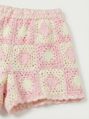 detail van gehaakte stof beige roze patroon