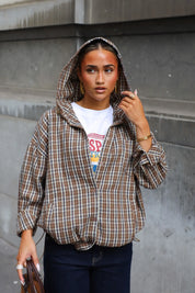 Geruite camel blouse met capuchon en lange mouwen gedragen met een wit T-shirt en donkerblauwe jeans