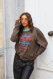 Bruine dames longsleeve met Champions opdruk en felblauwe ronde hals