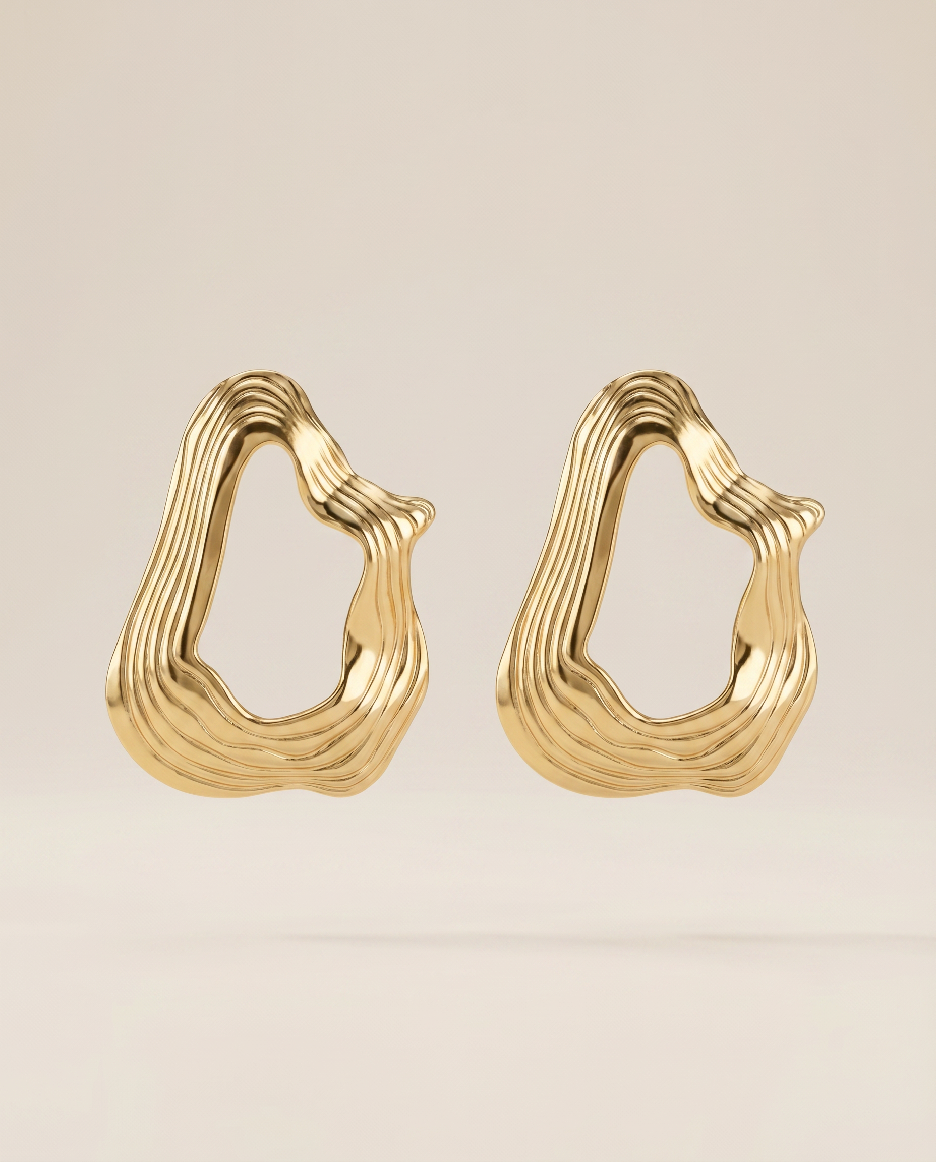 gouden wavy oorbellen close up productfoto