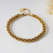 Stainless steel schakelarmband goud met gevlochten structuur en verlengkettinkje