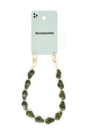 Groene telefoonkoord met goudkleurige clip aan houder